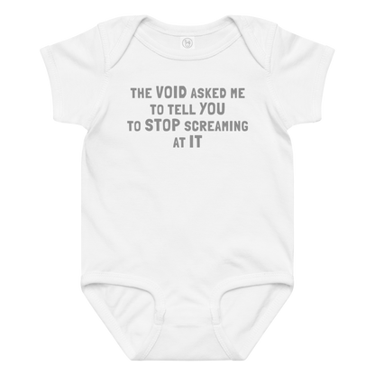 "The Void asked me to tell you to stop screaming at it" printed on a white baby jersey bodysuit laying on a flat surface amongst other clothes