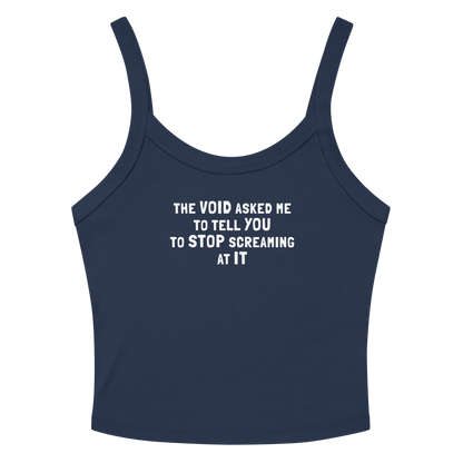 "The Void asked me to tell you to stop screaming at it" printed on a solid navy blend women's micro-rib tanktop laying on a flat surface amongst sunglasses and shorts
