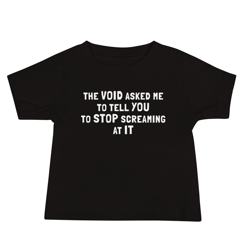 "The Void asked me to tell you to stop screaming at it" printed on a black baby jersey short sleeve tee laying on a flat surface
