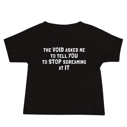 "The Void asked me to tell you to stop screaming at it" printed on a black baby jersey short sleeve tee laying on a flat surface