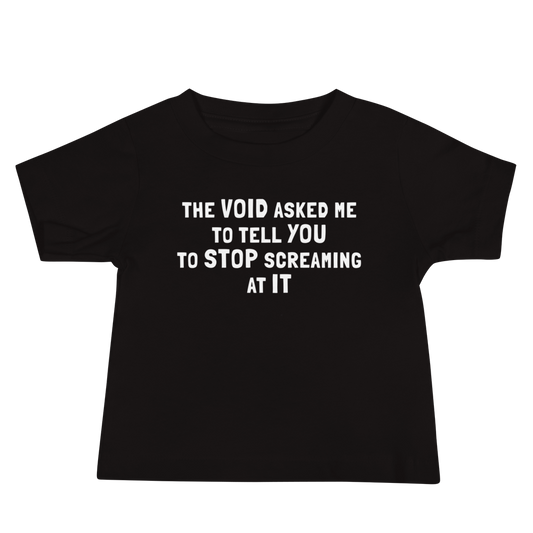 "The Void asked me to tell you to stop screaming at it" printed on a black baby jersey short sleeve tee laying on a flat surface