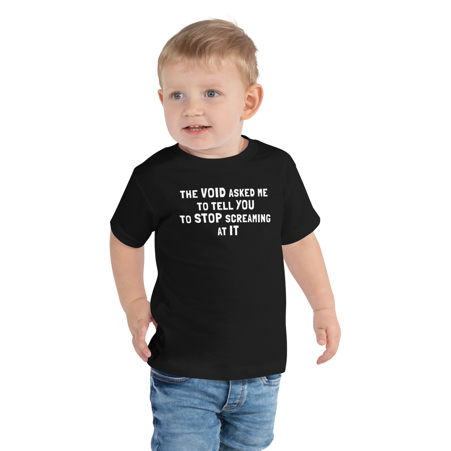 "The Void asked me to tell you to stop screaming at it" printed on a black toddler short sleeve tee worn by a male
