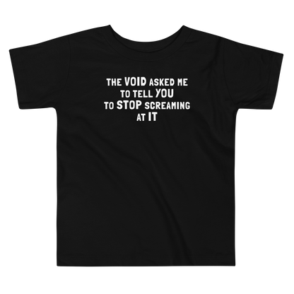 "The Void asked me to tell you to stop screaming at it" printed on a black toddler short sleeve tee laying on a flat surface