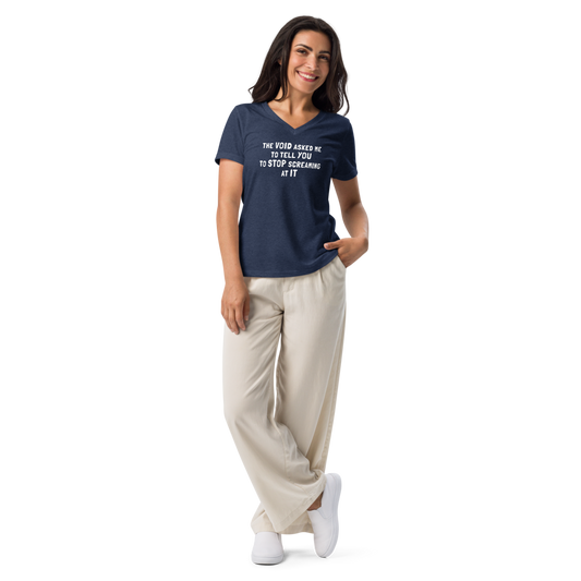"The Void asked me to tell you to stop screaming at it" printed on a heather navy women's relaxed v-neck t-shirt worn by a female