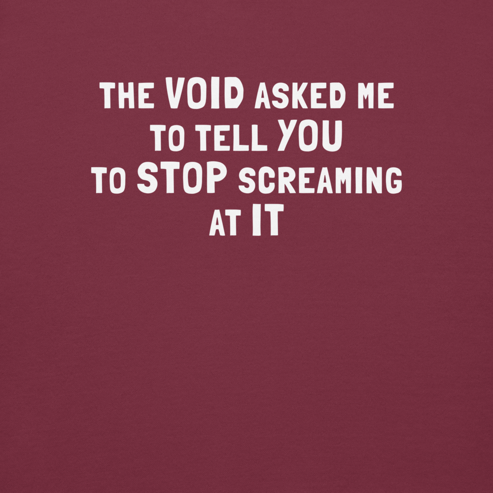 "The Void asked me to tell you to stop screaming at it" printed on a maroon background