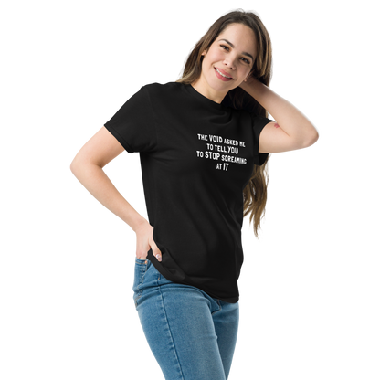 "The Void asked me to tell you to stop screaming at it" printed on a black unisex classic tee worn by a female
