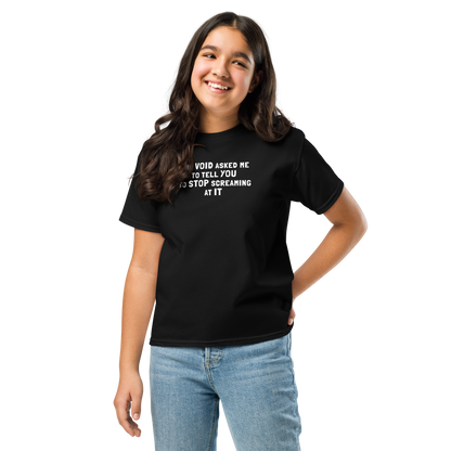 "The Void asked me to tell you to stop screaming at it" printed on a black youth classic tee worn by a female