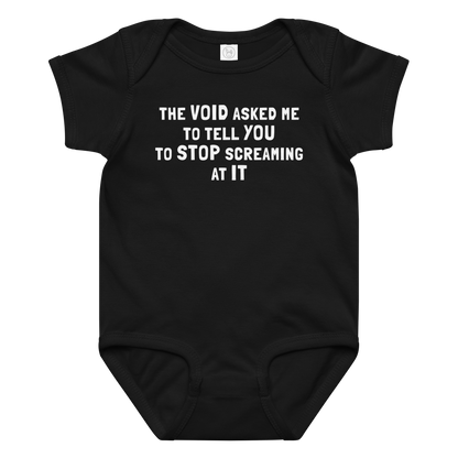 "The Void asked me to tell you to stop screaming at it" printed on a black baby jersey bodysuit laying on a flat surface amongst other clothes