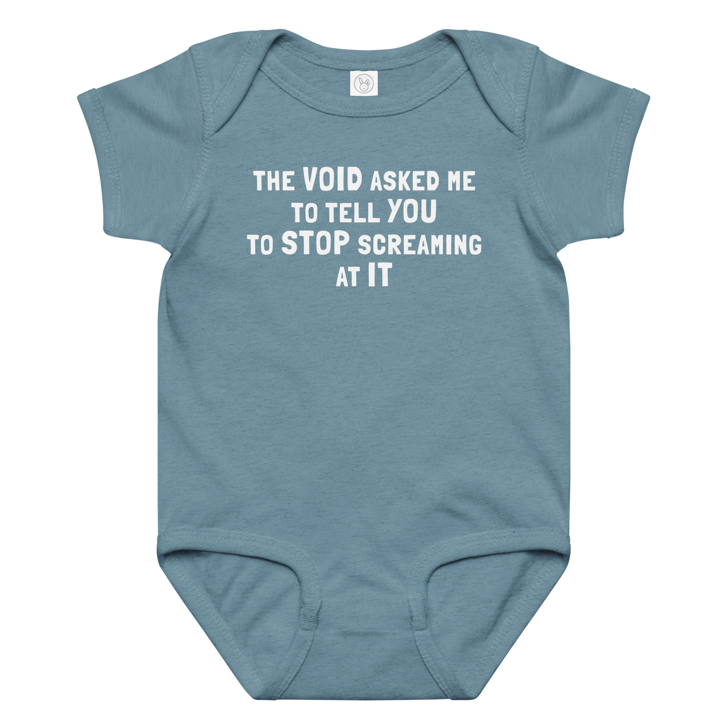 "The Void asked me to tell you to stop screaming at it" printed on a vintage indigo baby jersey bodysuit laying on a flat surface amongst other clothes