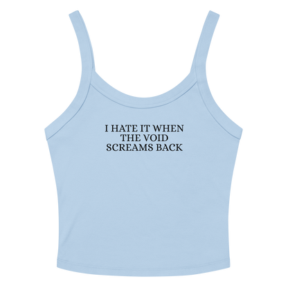 "I hate it when the void screams back" printed on a solid baby blue blend women's micro-rib tanktop laying on a flat surface amongst sunglasses and shorts