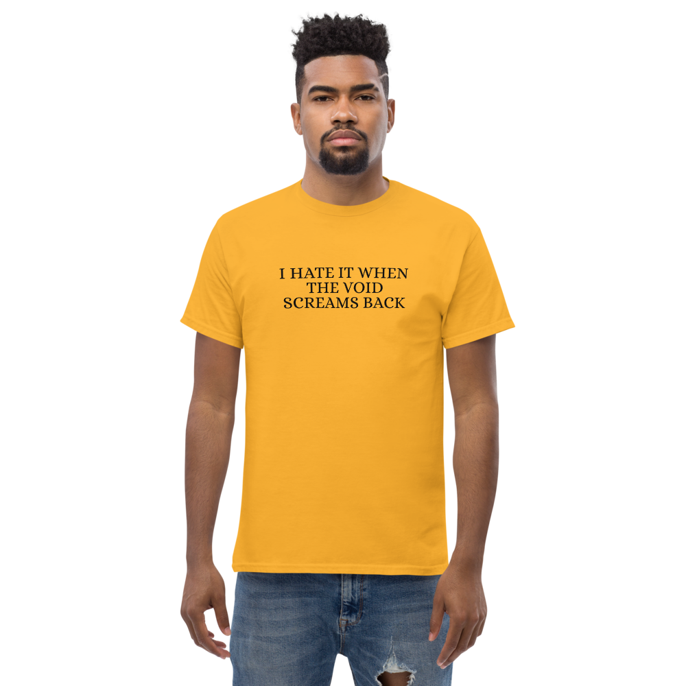 "I hate it when the void screams back" printed on a gold unisex classic tee worn by a male