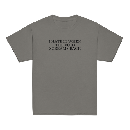 "I hate it when the void screams back" printed on a charcoal youth classic tee laying on a flat surface