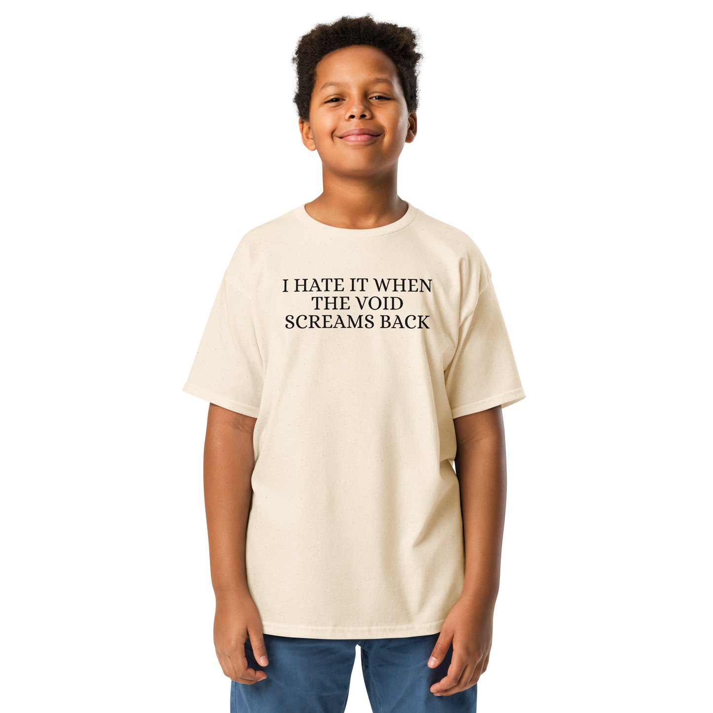 "I hate it when the void screams back" printed on a natural youth classic tee worn by a male