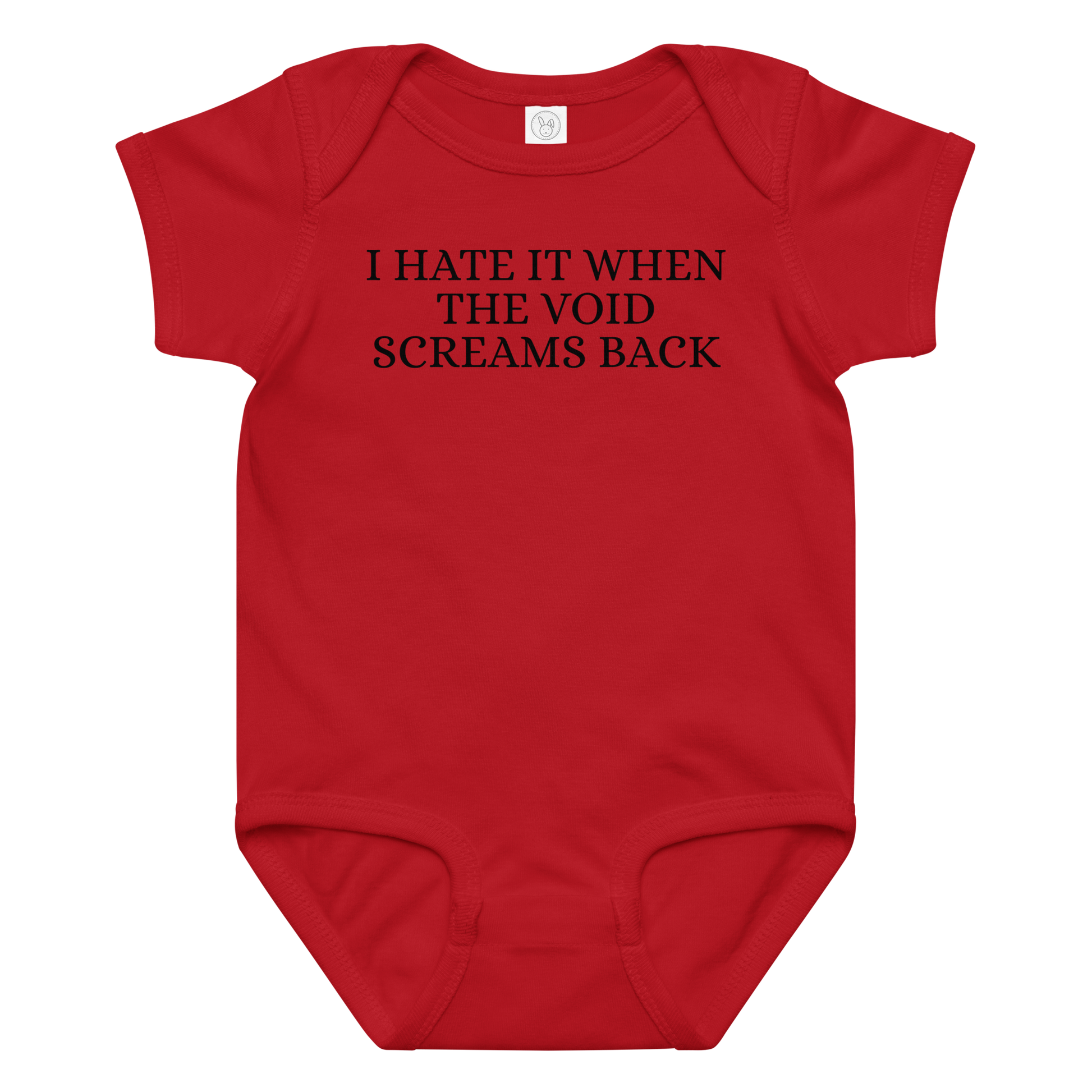 "I hate it when the void screams back" printed on a red baby jersey bodysuit laying on a flat surface amongst other clothes