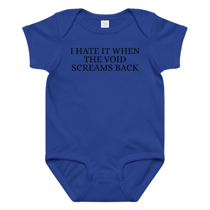 "I hate it when the void screams back" printed on a royal baby jersey bodysuit laying on a flat surface amongst other clothes