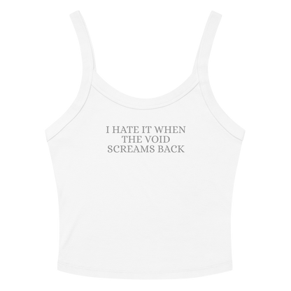 "I hate it when the void screams back" printed on a solid white blend women's micro-rib tanktop laying on a flat surface amongst sunglasses and shorts