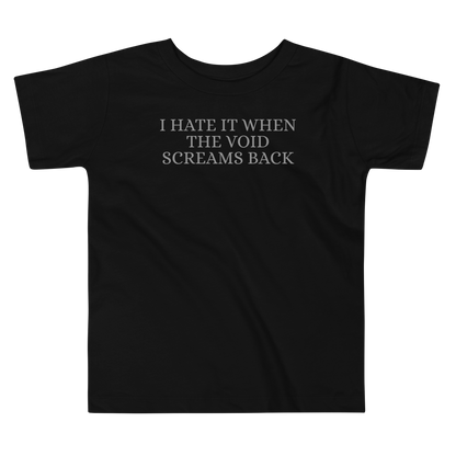 "I hate it when the void screams back" printed on a black toddler short sleeve tee laying on a flat surface