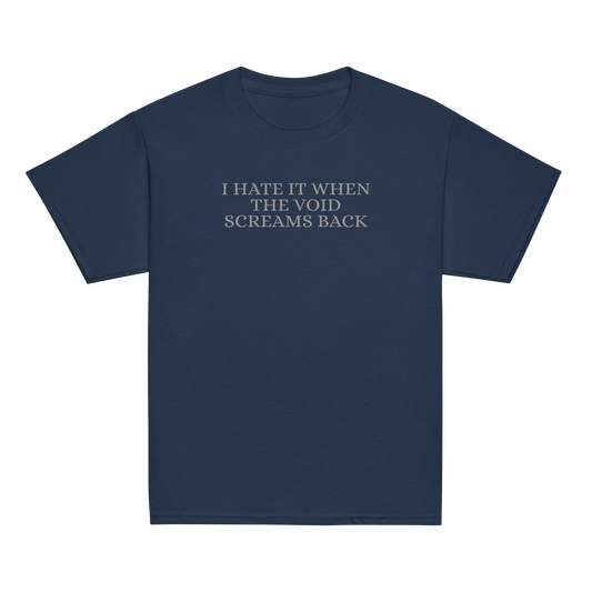 "I hate it when the void screams back" printed on a navy youth classic tee laying on a flat surface