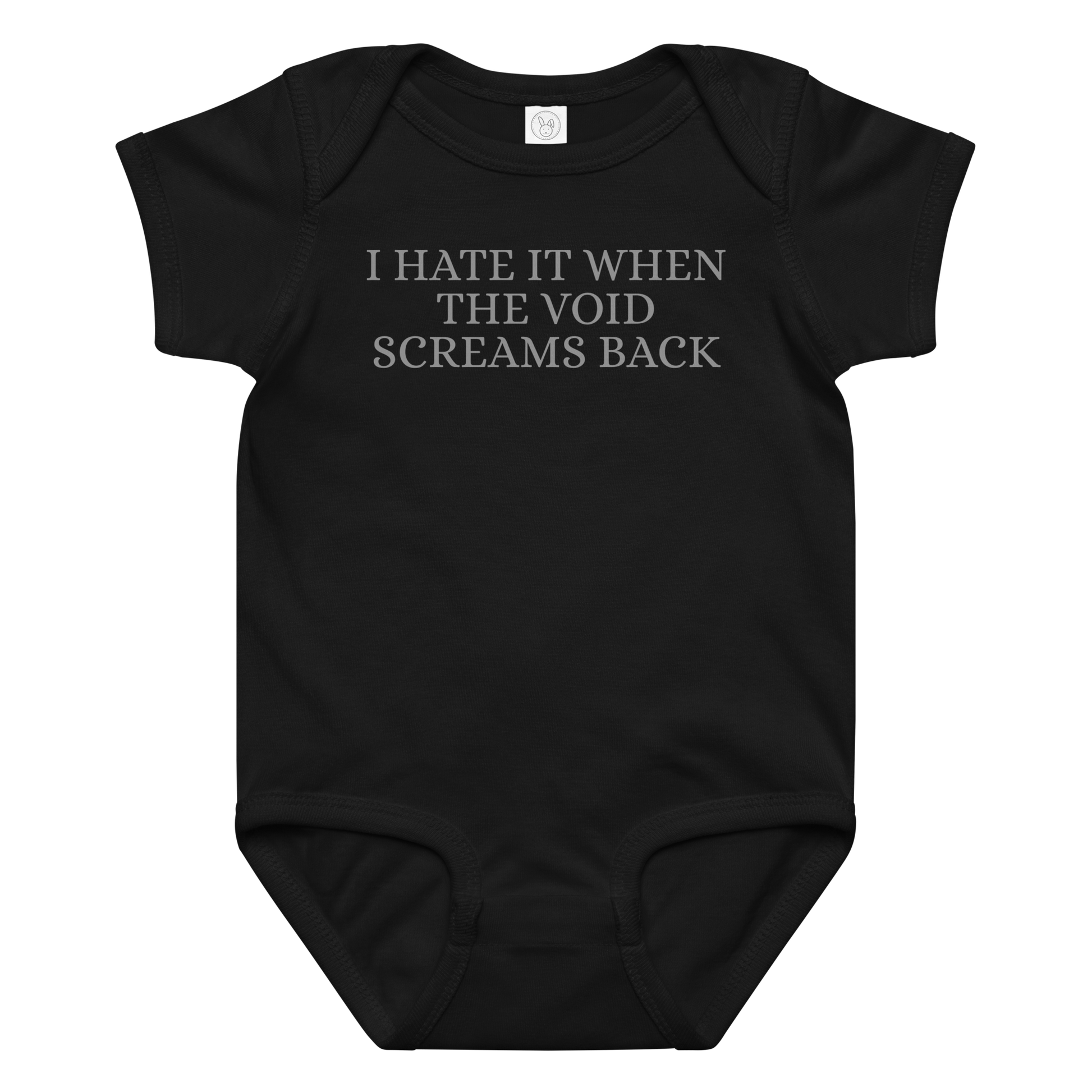 "I hate it when the void screams back" printed on a black baby jersey bodysuit laying on a flat surface amongst other clothes