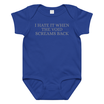 "I hate it when the void screams back" printed on a royal baby jersey bodysuit laying on a flat surface amongst other clothes
