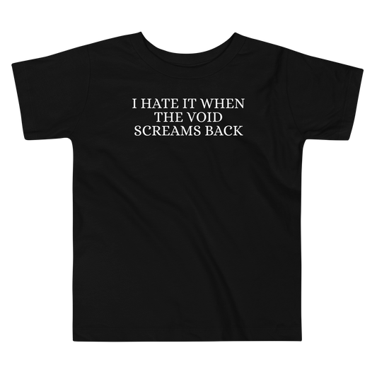 "I hate it when the void screams back" printed on a black toddler short sleeve tee laying on a flat surface