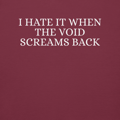 "I hate it when the void screams back" printed on a maroon background