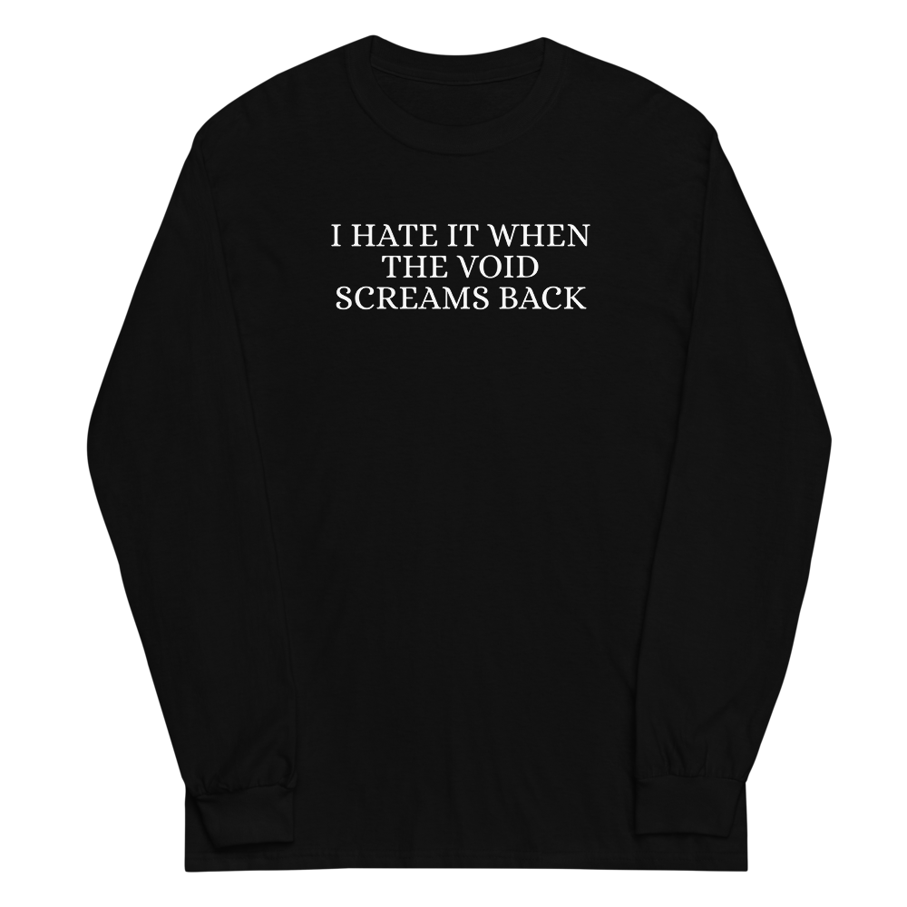 "I hate it when the void screams back" printed on a black men's long sleeve shirt laying on a flat surface