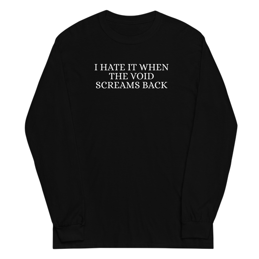 "I hate it when the void screams back" printed on a black men's long sleeve shirt laying on a flat surface