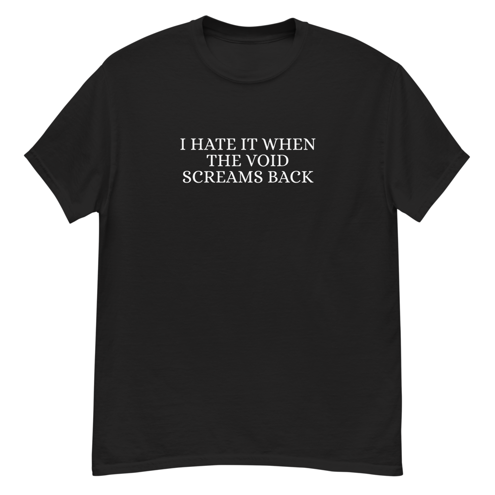 "I hate it when the void screams back" printed on a black unisex classic tee laying on a flat surface