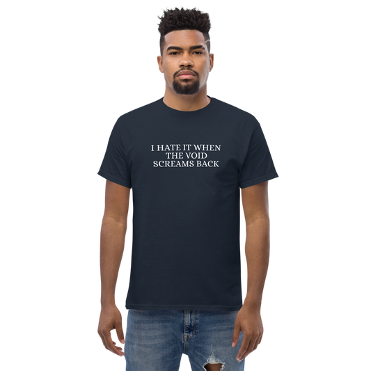 "I hate it when the void screams back" printed on a navy unisex classic tee worn by a male