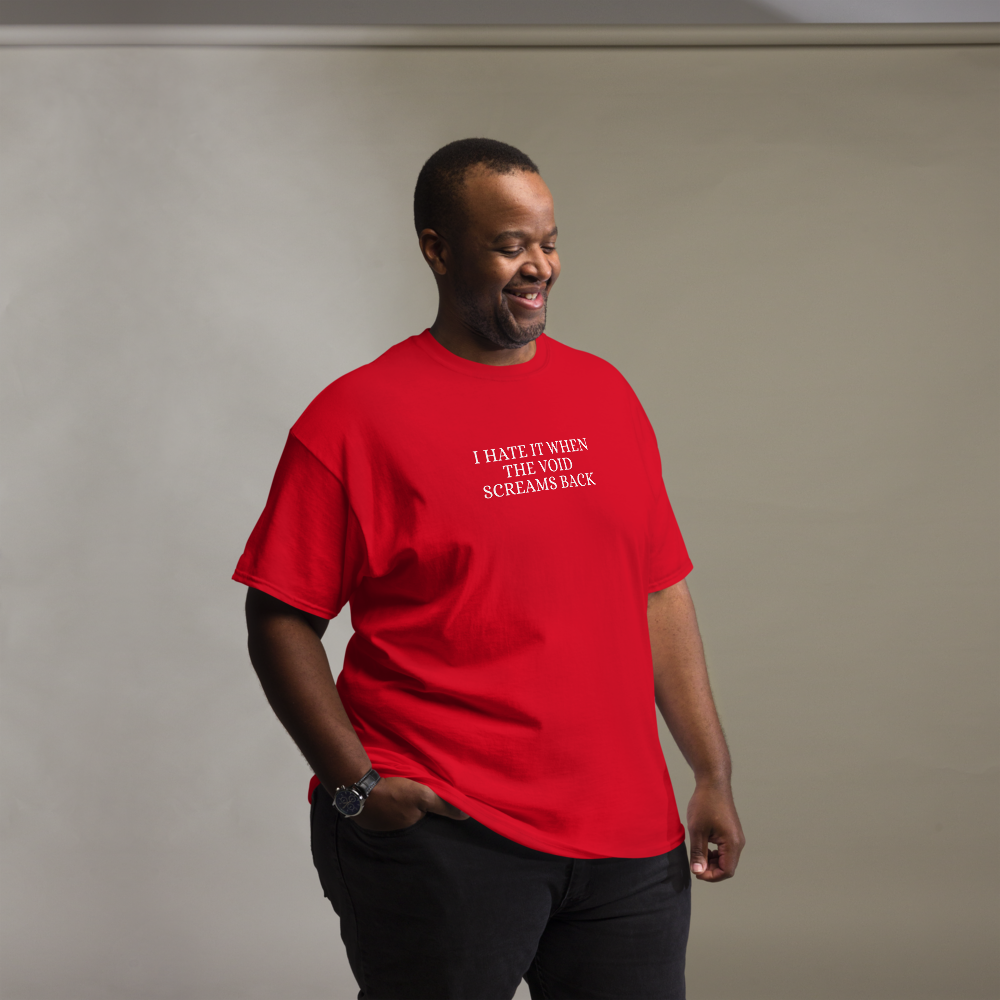 "I hate it when the void screams back" printed on a red unisex classic tee worn by a male