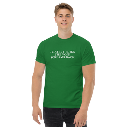 "I hate it when the void screams back" printed on a turf green unisex classic tee worn by a male