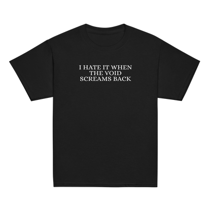 "I hate it when the void screams back" printed on a black youth classic tee laying on a flat surface