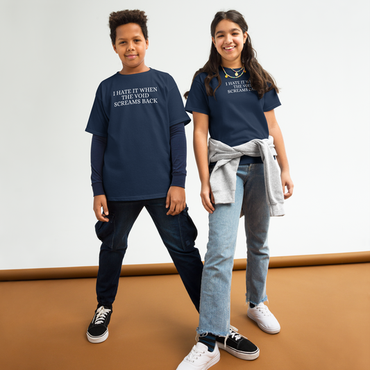 "I hate it when the void screams back" printed on a navy youth classic tee worn by a female and male