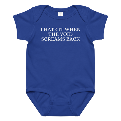 "I hate it when the void screams back" printed on a royal baby jersey bodysuit laying on a flat surface amongst other clothes