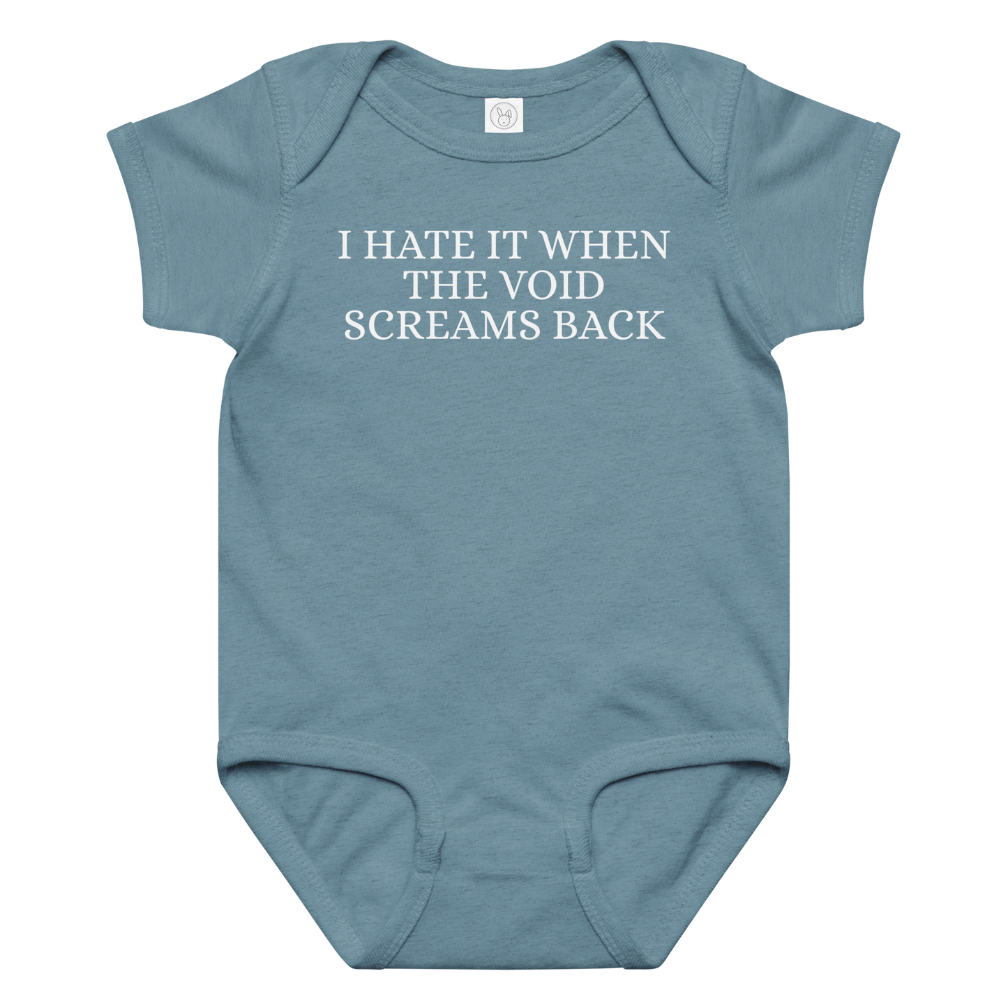 "I hate it when the void screams back" printed on a vintage indigo baby jersey bodysuit laying on a flat surface amongst other clothes