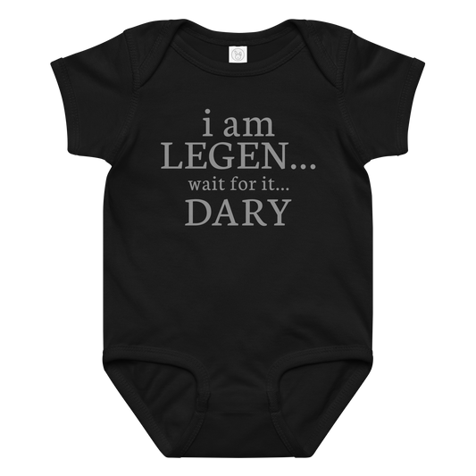"I Am Legen... Wait For It... Dary" printed on a black baby jersey bodysuit laying on a flat surface amongst other clothes