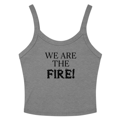 "We are the fire!" printed on a athletic heather women's micro-rib tanktop laying on a flat surface amongst sunglasses and shorts