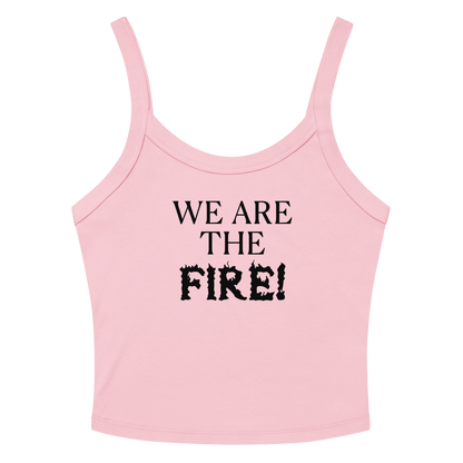 "We are the fire!" printed on a solid pink blend women's micro-rib tanktop laying on a flat surface amongst sunglasses and shorts