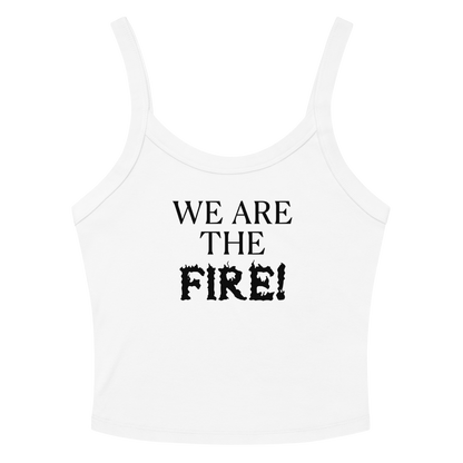 "We are the fire!" printed on a solid white blend women's micro-rib tanktop laying on a flat surface amongst sunglasses and shorts