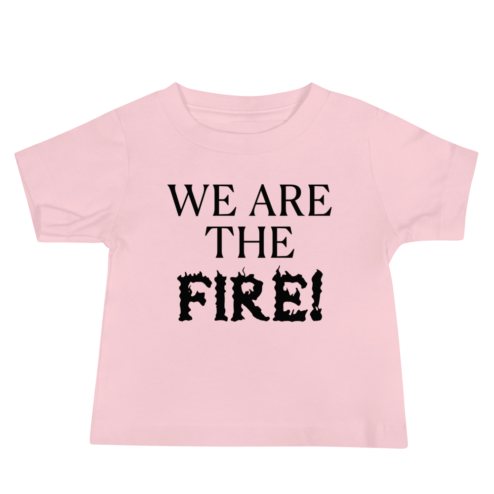 "We are the fire!" printed on a pink baby jersey short sleeve tee laying on a flat surface