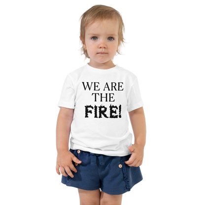 "We are the fire!" printed on a white toddler short sleeve tee worn by a female