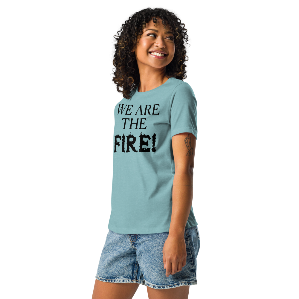 "We are the fire!" printed on a heather blue lagoon women's relaxed t-shirt worn by a female