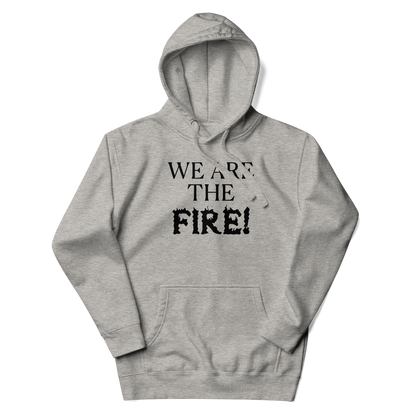 "We are the fire!" printed on a carbon grey unisex hoodie laying on a flat surface with the hood up
