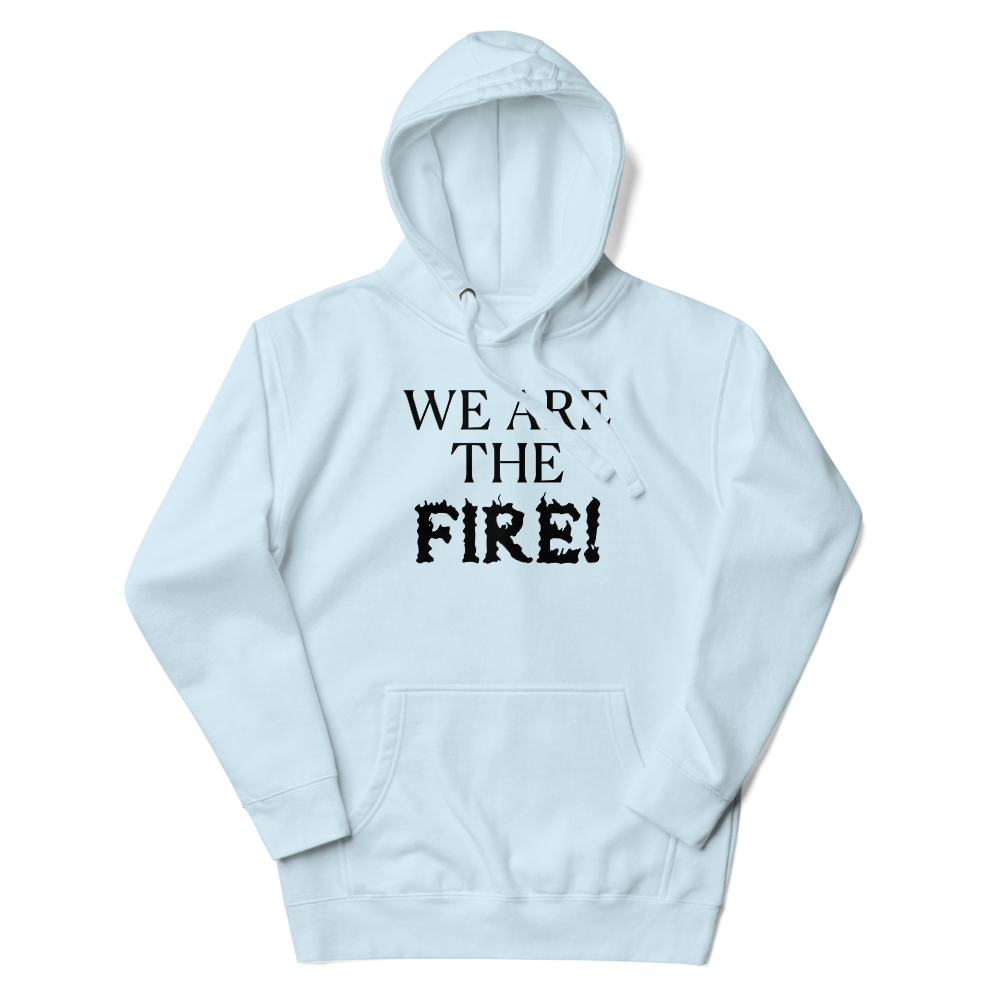 "We are the fire!" printed on a sky blue unisex hoodie laying on a flat surface with the hood up