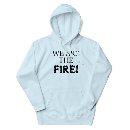 "We are the fire!" printed on a sky blue unisex hoodie laying on a flat surface with the hood up