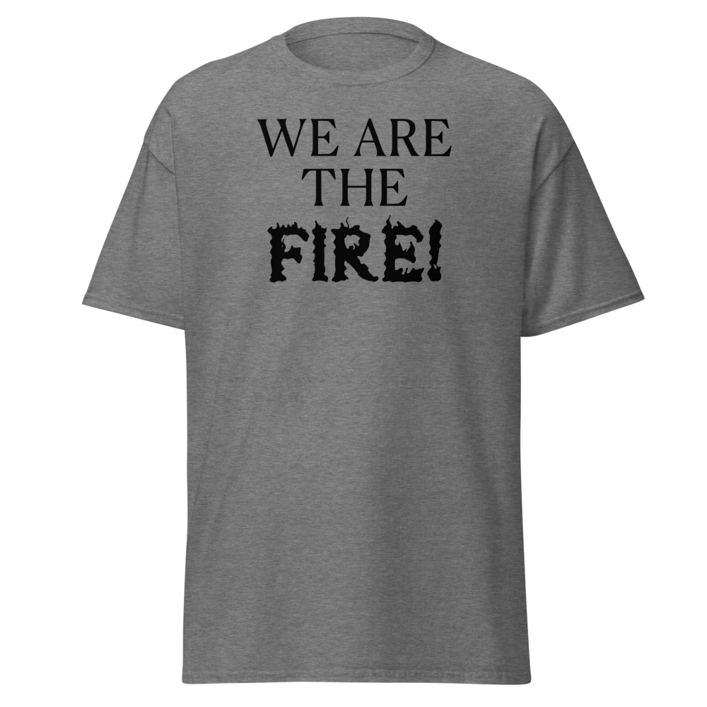 "We are the fire!" printed on a graphite heather unisex classic tee laying on a flat surface