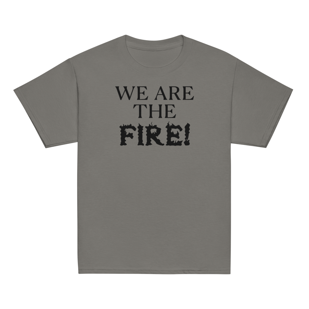 "We are the fire!" printed on a charcoal youth classic tee laying on a flat surface