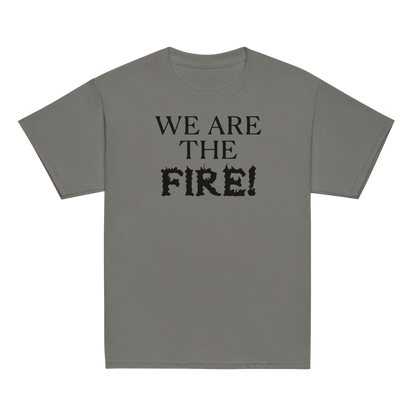 "We are the fire!" printed on a charcoal youth classic tee laying on a flat surface