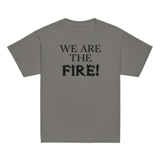 "We are the fire!" printed on a charcoal youth classic tee laying on a flat surface